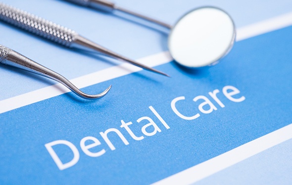 Dental instruments lying on a piece of paper that reads “Dental Care”