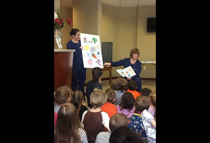 Team members teaching kids about oral health