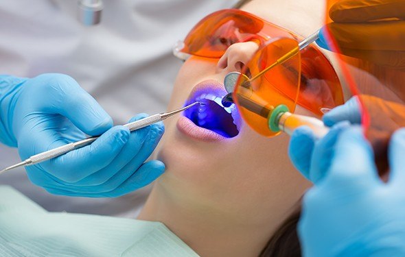 Patient receiving dental sealants