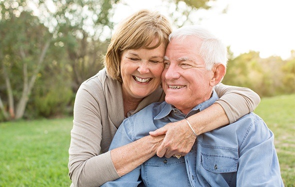 Smiling older man and woman outdoors