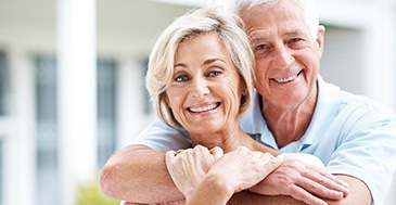 Smiling older man and woman outdoors