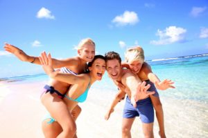 family having fun on the beach 